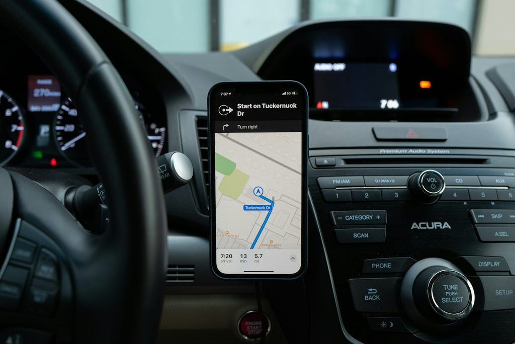 Black smartphone mounted on car center console