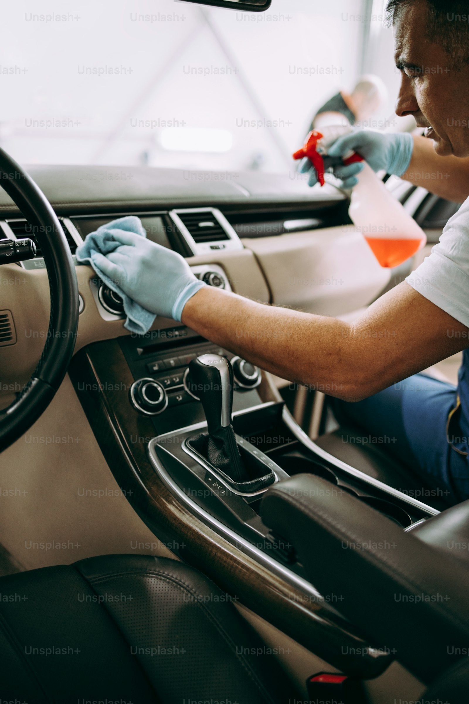 Hand cleaning luxurious leather car interior seats